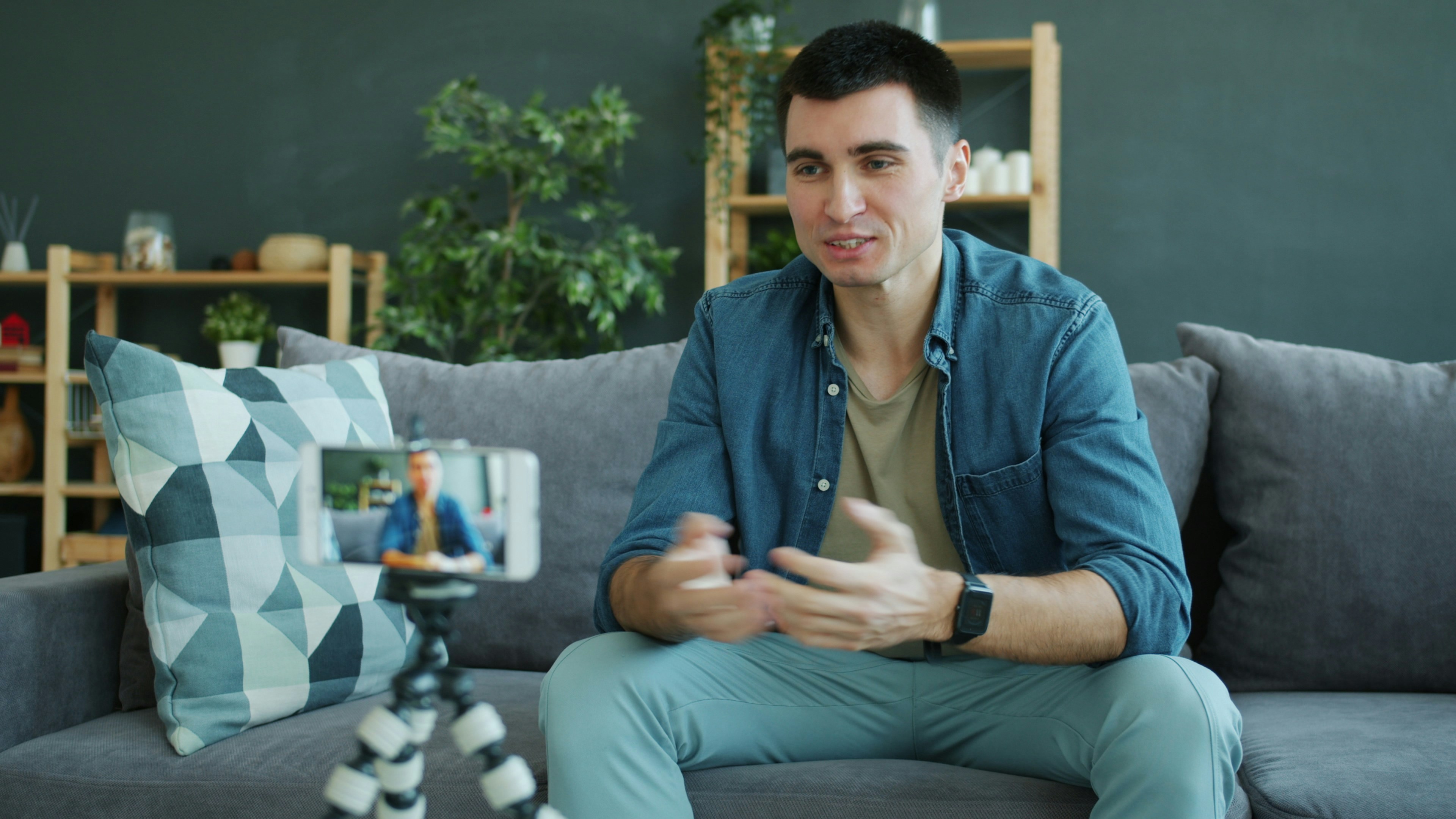 Man talking to a smartphone camera mounted on a tripod